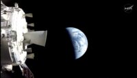 Image from Orion: Thrusters in foreground to the left, Earth in center of image